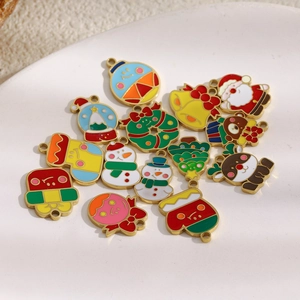 Close-up of 18K gold plated Christmas charms like Santa and tree in a ceramic dish