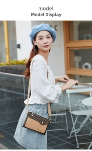 Close-up of contrast crossbody bag featuring vintage monogram pattern and gold metal hardware
