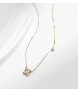 Macro shot of gold S925 sterling silver necklace with square cubic zirconia pendant