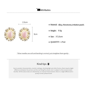 Detailed view of vintage oval stud earrings with pink resin and faux pearl accents