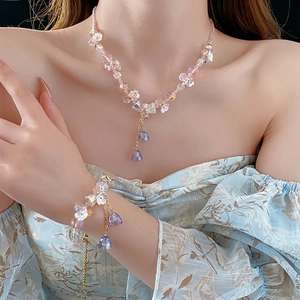 Floral crystal tassel necklace and bracelet set with pink beads and gold accents
