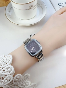 Elegant ladies square watch with silver steel band and dark grey dial in a lifestyle setting