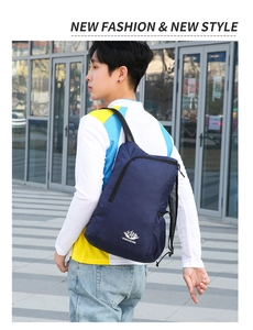 Outdoor street style shot of a lightweight dark blue foldable sports backpack for hiking