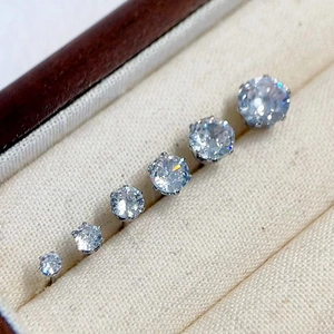 Detailed close-up of six round zircon stud earrings in a classic six-prong steel setting