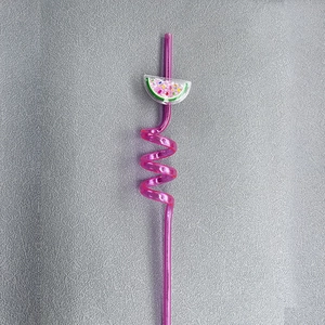 Close-up of pink spiral plastic straw with sparkling fruit slice glitter charm detail