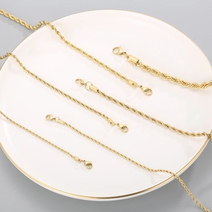 Golden titanium steel twist rope chain necklaces in multiple sizes on a luxury tray