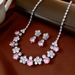 Detailed view of vintage zircon flower necklace and earring set in pink and white stones