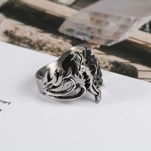 Macro detail of vintage silver titanium steel ring with hollow phoenix and dragon design