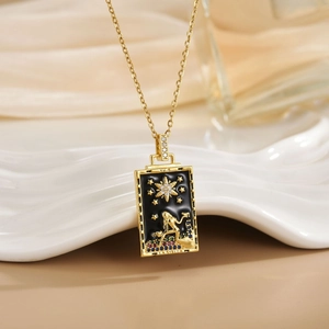 Detailed macro shot of a gold tarot star necklace featuring enamel and sparkling zircons