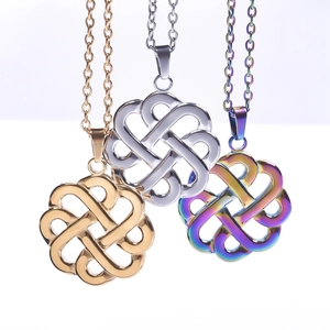 Detailed view of three stainless steel Celtic witch knot pendants in gold, silver, and rainbow