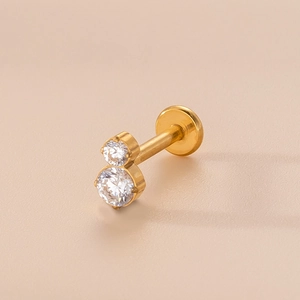 Detailed macro shot of golden labret stud with vertical double round zircon stones