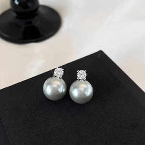 Minimalist grey pearl stud earrings with sparkling top diamond on black matte base