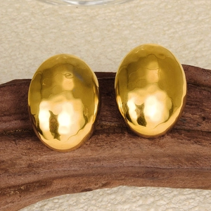 Macro shot of 304 stainless steel gold earrings with hammered oval texture on wood