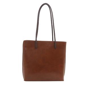 Brown faux leather tote bag with long shoulder straps in a minimalist urban fashion style