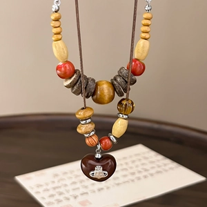 Vintage wooden beaded long necklace with red accents and heart pendant with orb logo