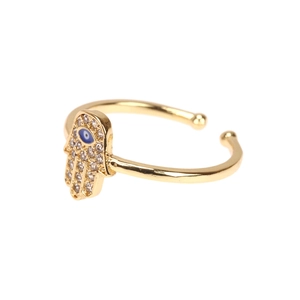 Detail of gold Hamsa Hand open ring with blue evil eye and sparkling zircons
