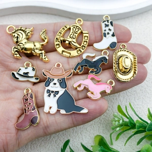 Macro shot of colorful enamel western cowboy charms held in hand for jewelry making
