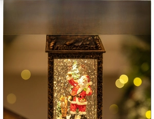 Macro shot of bronze Christmas lantern with Santa, reindeer, and rotating glitter
