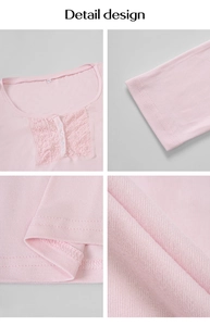 Close-up of pink long-sleeve knit top featuring white lace trim and button neckline