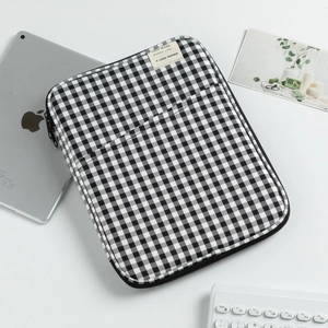 Checkered 13-inch laptop sleeve with black and white grid pattern and front pocket