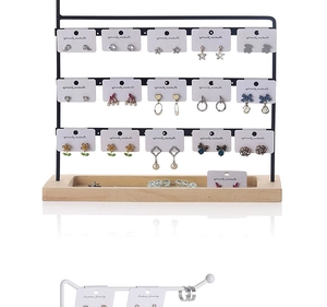 Macro detail of multi-layer metal earring holder with a natural wooden base organizer