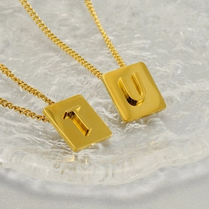 Golden stainless steel necklace featuring rectangular 3D alphabet T and U pendants