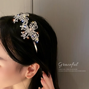 Elegant silver headband featuring sparkling crystal butterflies on a brunette model