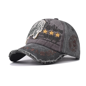 Close-up of vintage washed denim baseball cap with embroidery and distressed brim edge