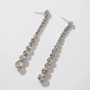 Detail of silver long tassel earrings with sparkling rhinestones in a linear drop design
