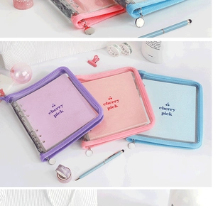 Detail view of multi-color PVC loose-leaf binders with cherry logos and metal zippers