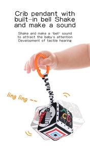 Detail of crib pendant toy with high-contrast black and white patterns and built-in bell