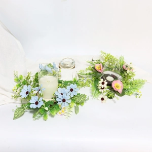 Detail of blue and pink silk flower wreaths for candles and wedding table decor