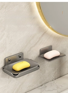 Detail view of wall-mounted aluminum soap dish showing the double-layer drainage tray