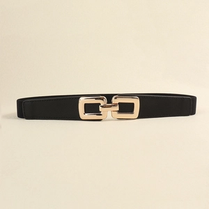 Close-up of women's black elastic belt with a polished gold interlocking metal buckle