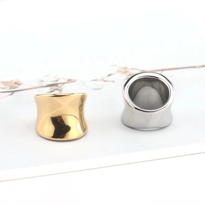 Detail view of gold and silver stainless steel rings with smooth inner arc finish