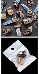 Detail of natural kyanite pendant with vintage bronze metal wrap and packaging bag