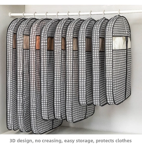 Set of houndstooth garment bags in multiple lengths hanging neatly inside a white closet