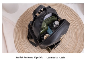 Internal view of black quilted backpack showing storage for cosmetics and essentials