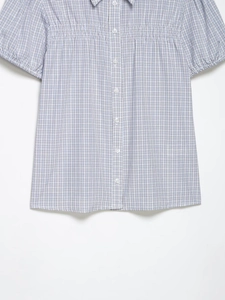 Detail of blue and white checkered short sleeve shirt with pleated waist and collar