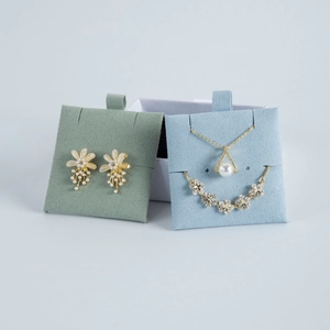 Elegant gold flower earrings, pearl necklace and star bracelet jewelry set on display
