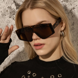 Side view of oversized tortoise frame sunglasses with brown lenses worn by a model