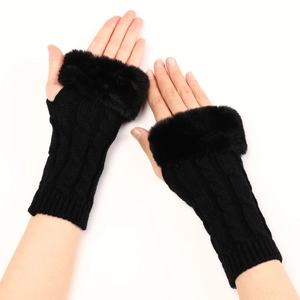 Close-up detail of black cable knit gloves with fluffy faux rabbit fur trim for women