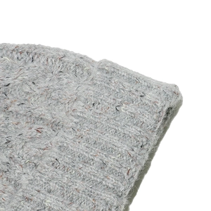 Detailed close-up of grey knit beanie with colorful speckled fiber texture and wool blend