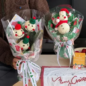 Handmade crochet snowman flower bouquet with Christmas wrapping and festive ribbons