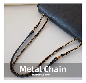 Detailed close-up of premium black leather texture and elegant gold hardware chain