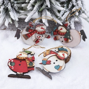 Set of 4 wooden snowman Christmas ornaments hanging on snowy pine tree branches