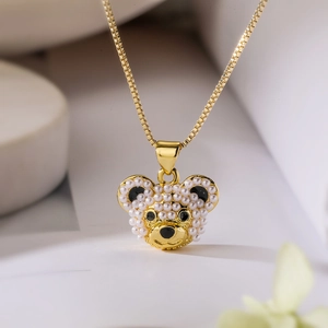 Elegant gold-plated bear pendant necklace with white pearls and black stone details