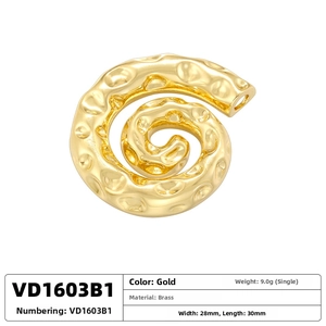 Macro shot of gold brass spiral shell pendant with hammered texture and dimensions