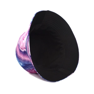 Detail of a reversible tie-dye bucket hat with colorful marble print and black lining