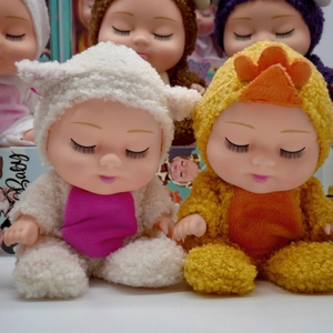 Detail of 8-inch sleeping baby dolls in soft animal plush onesies with long eyelashes